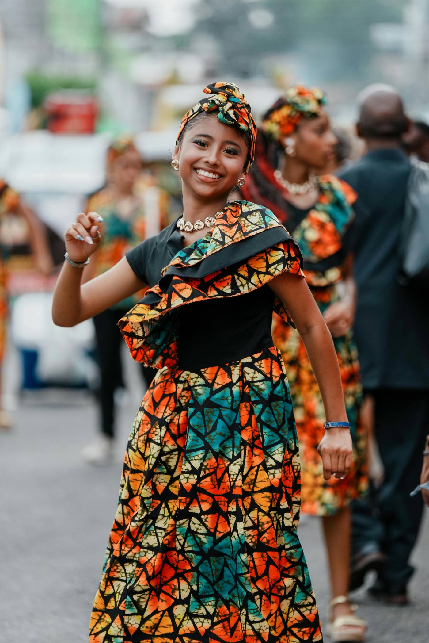A joyful woman in vibrant traditional dress